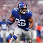 NY Giants' running back Saquon Barkley in action on the field.